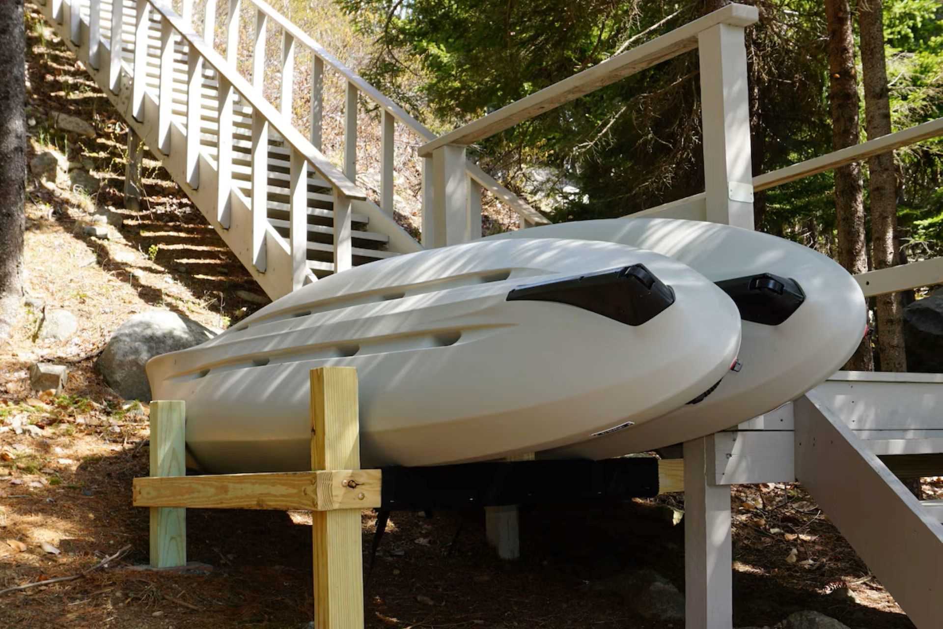 2 Kayaks on their storage rack near shore