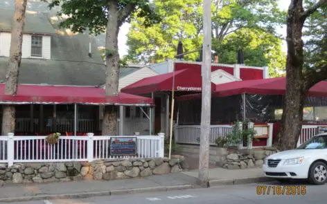 A red umbrella is on the side of a building.