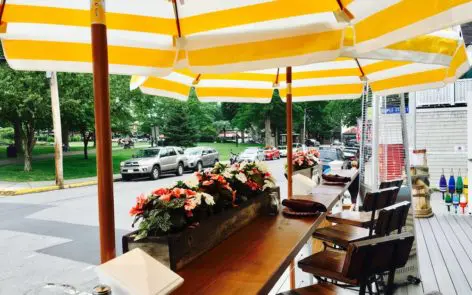 A table with chairs and flowers on it