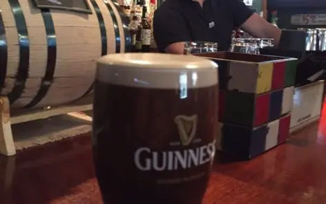 A guinness beer is sitting on the table.