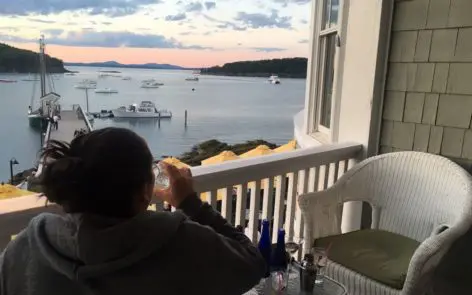 A man sitting at the table drinking wine.