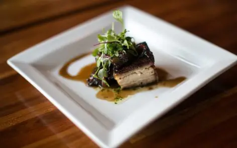 A plate of food on top of a wooden table.