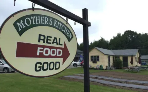 A sign that says real food good and mother 's kitchen.