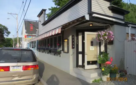 A car parked in front of a restaurant.