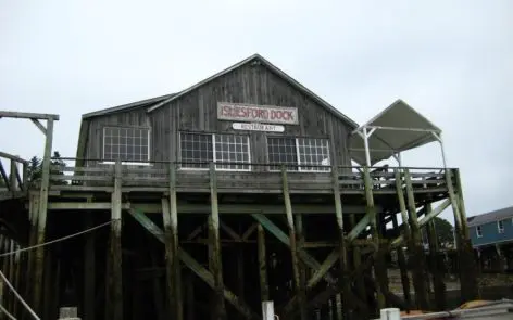 A wooden building with a sign on it's side.