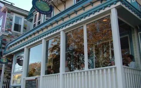 A building with many windows and a sign on the front.