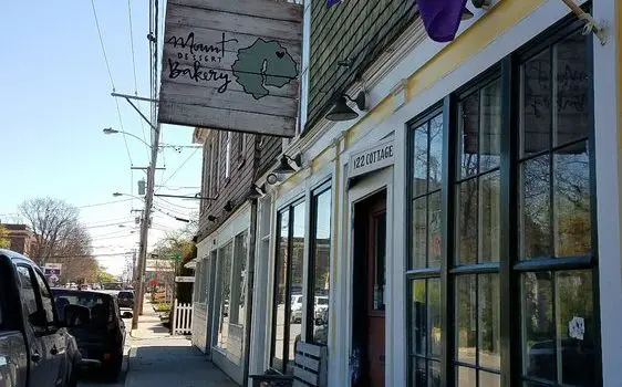 A street view of several businesses on the side of a road.