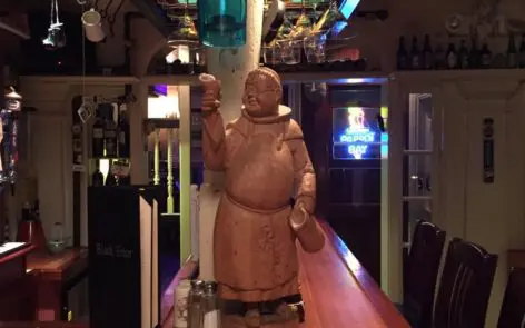 A statue of a woman is on the bar.